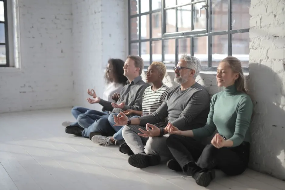 team practicing mindfulness during virtual meeting - wellbeing activities for virtual team meetings