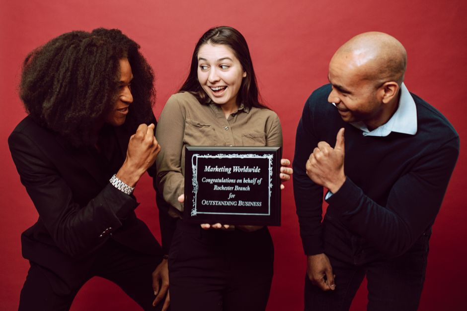 happy diverse team celebrating recognition achievements - employee rewards and recognition software
