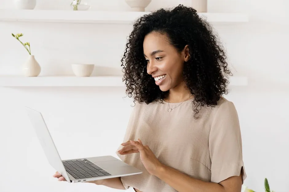 person smiling at laptop - virtual ice breakers