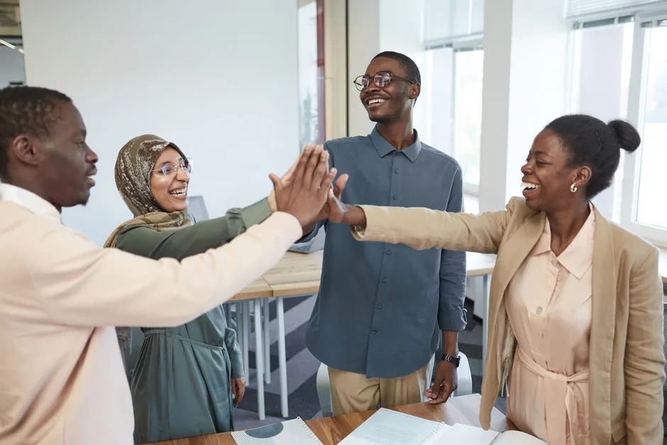 A diverse team celebrating CSR milestones - examples of corporate social responsibility